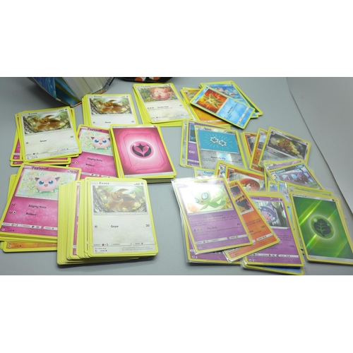 845 - Thirty Holo/reverse Holo and 300 common/uncommon/rare Pokemon cards, in tin