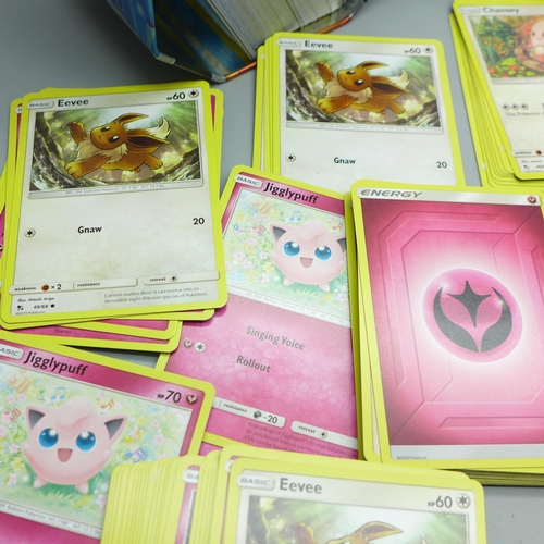 845 - Thirty Holo/reverse Holo and 300 common/uncommon/rare Pokemon cards, in tin