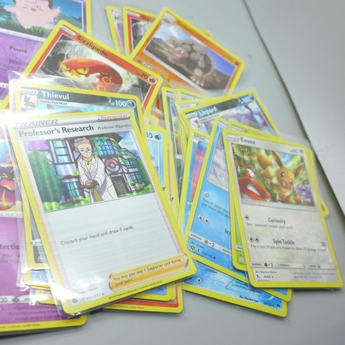 845 - Thirty Holo/reverse Holo and 300 common/uncommon/rare Pokemon cards, in tin