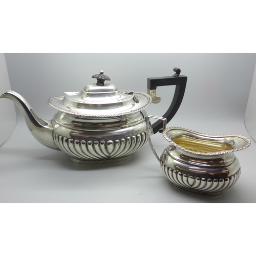 860 - A silver tea pot and a silver cream jug, 768g gross weight