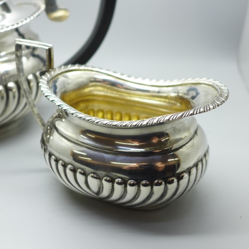 860 - A silver tea pot and a silver cream jug, 768g gross weight