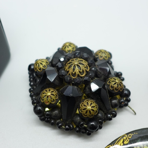 895 - Jet brooches, bracelet with black stones, signed brooches, etc.