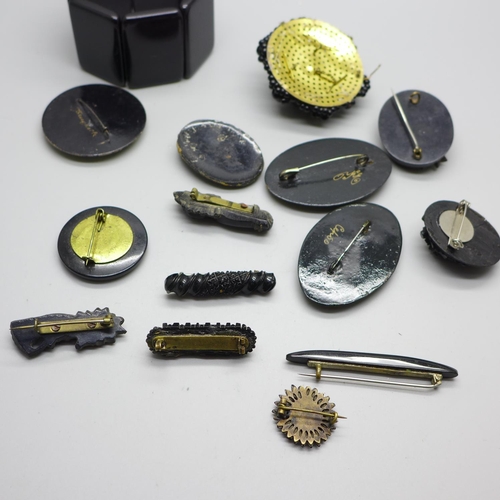 895 - Jet brooches, bracelet with black stones, signed brooches, etc.