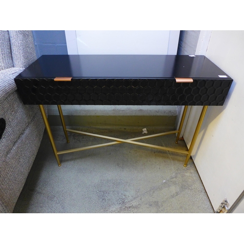 1669 - A black console table with gold legs