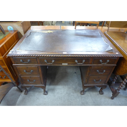 130 - An Edward VII Chippendale Revival carved mahogany pedestal desk