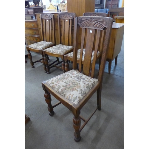 108A - A set of four carved oak dining chairs