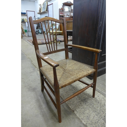 119 - A pair of child's Arts and Crafts mahogany rush seated chairs