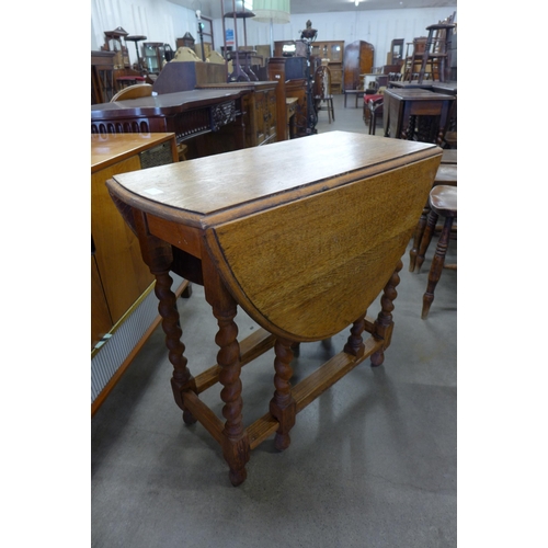 128 - An oak barleytwist gateleg table