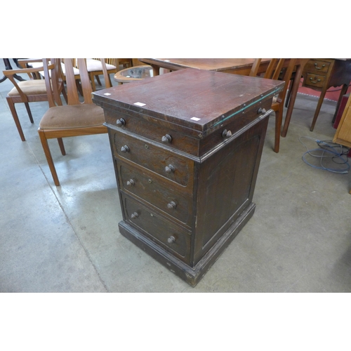 131 - A Victorian oak pedestal secretaire writing desk/games table