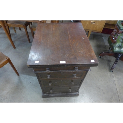 131 - A Victorian oak pedestal secretaire writing desk/games table