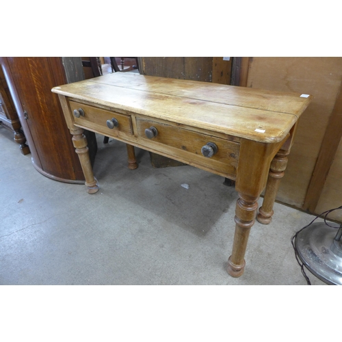 145 - A Victorian low pine two drawer kitchen table