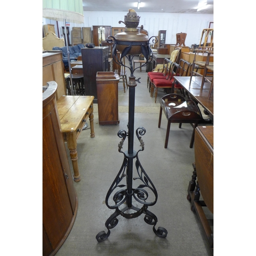 147 - A Victorian Aesthetic Movement wrought iron and copper floor standing oil lamp