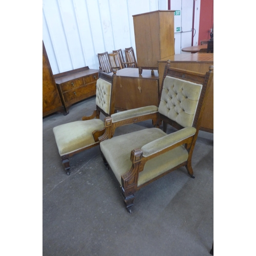 161 - A pair of Victorian Aesthetic Movement carved oak and green fabric upholstered lady's and gentleman'... 