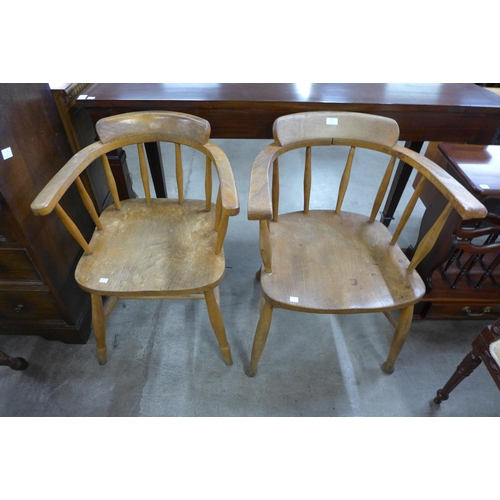 171 - A pair of similar elm and beech smokers bow chairs