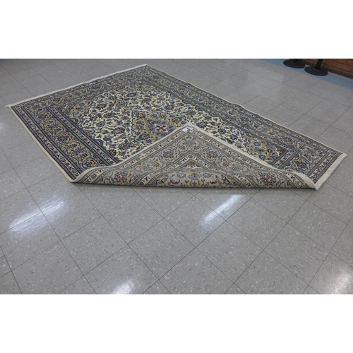 207 - A Persian cream ground Kashan rug, 295 x 200cms, a/f