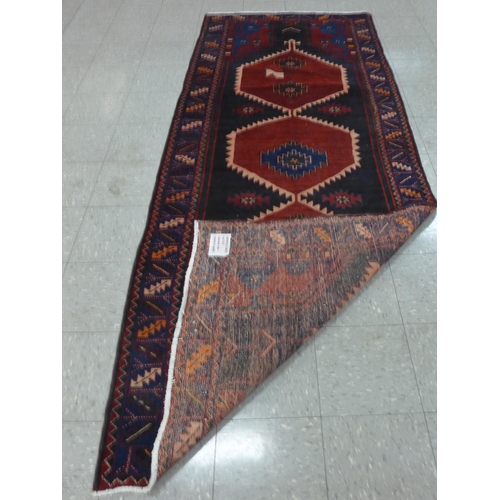 209 - A Persian red ground Hamadan runner rug, 115 x 298cms