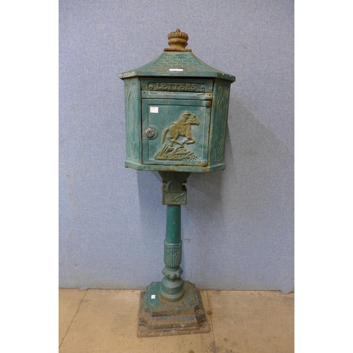 222 - A cast iron freestanding letter box, with key