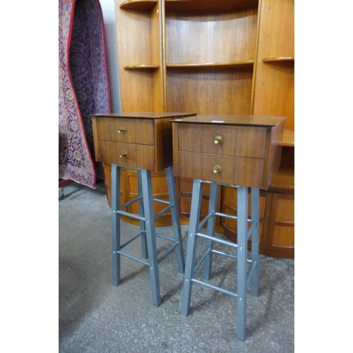 26 - A pair of afromosia two drawer chests on metal stands