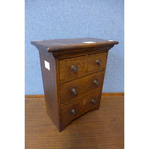 309A - A miniature/apprentice's George III style oak chest of drawers