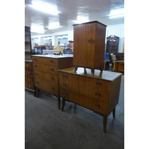 45 - An Afromosia three piece bedroom suite, comprising two chests of drawers and a pot cupboard