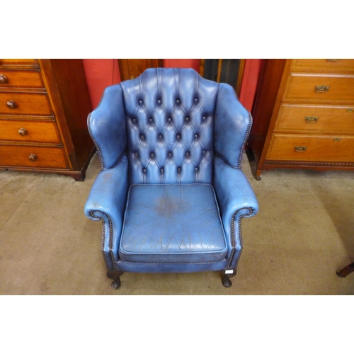 75 - A Chesterfield blue leather wingback armchair