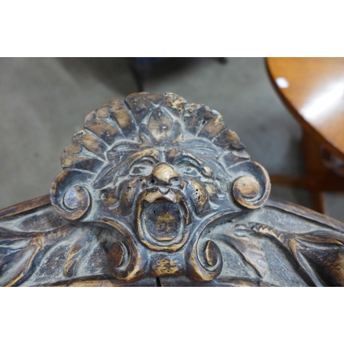 76 - A pair of Italian Baroque style carved corner chairs