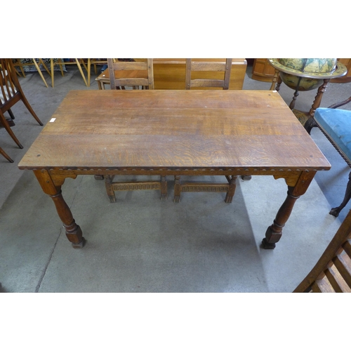 78 - A Nigel Griffiths carved oak dining table and four chairs