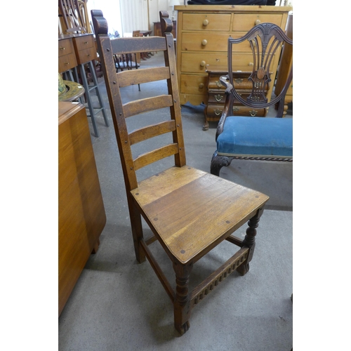 78 - A Nigel Griffiths carved oak dining table and four chairs