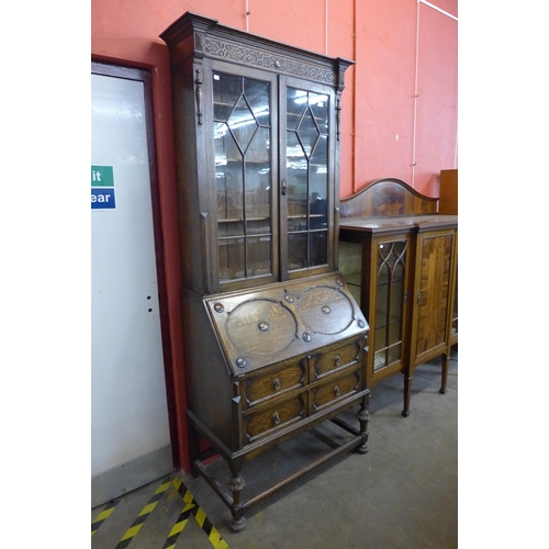 84 - An early 20th Century Jacobean Revival oak bureau bookcase