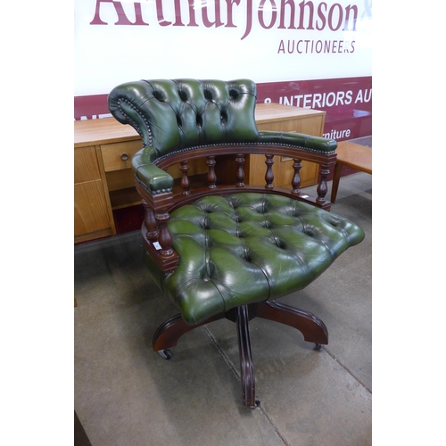 87 - A mahogany and green leather revolving Captain's desk chair