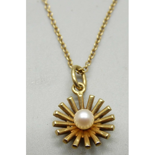 1037 - A 9ct gold pendant set with a pearl on a yellow metal chain, 2g