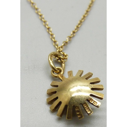 1037 - A 9ct gold pendant set with a pearl on a yellow metal chain, 2g