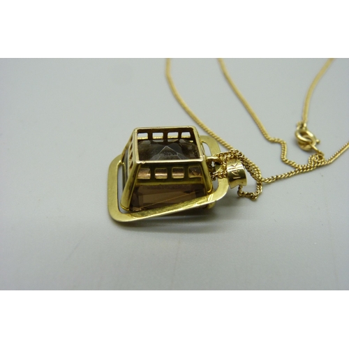 1043 - A 14ct gold pendant set with a smoky quartz, on an 18ct gold chain, 8.1g