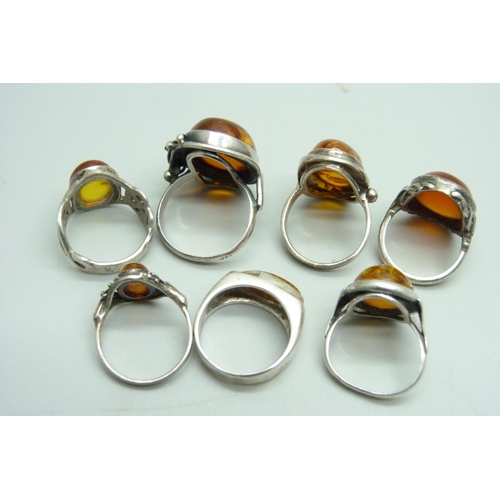 1063 - Seven silver and amber rings, 40g