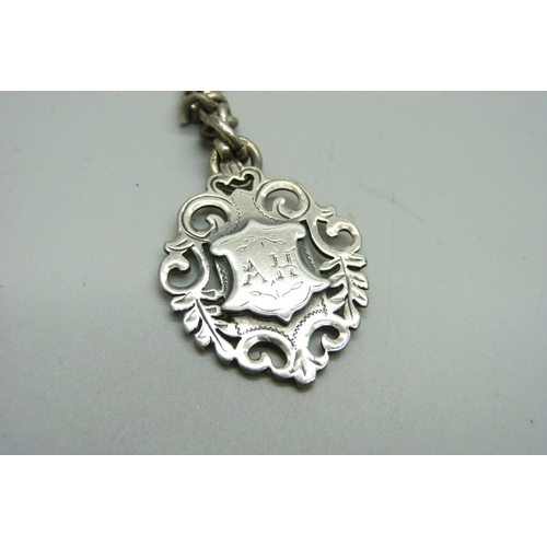 1075 - A silver double Albert chain and fob, 74g