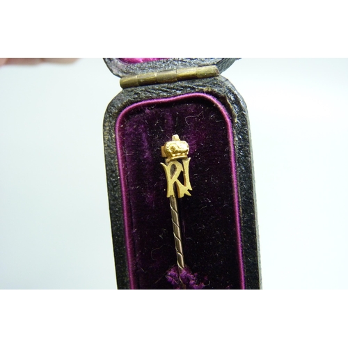 1077 - A gilt metal stick pin with crown motif, in original box