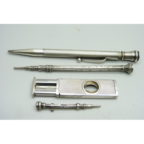 1080 - Two silver pencils and a white metal pencil with amethyst top, and a silver cigar cutter