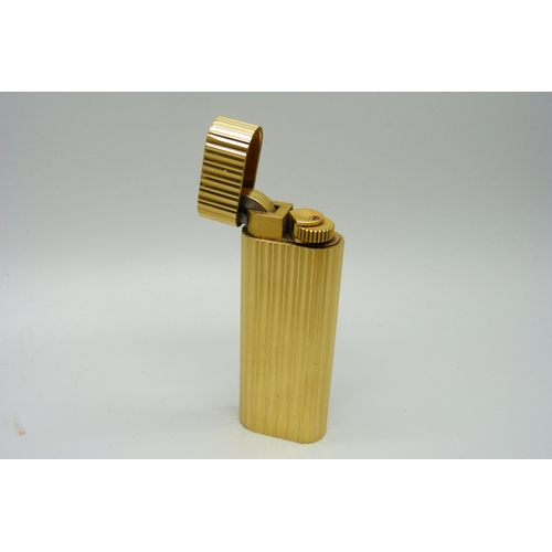 1083 - A Cartier gold plated cigarette lighter