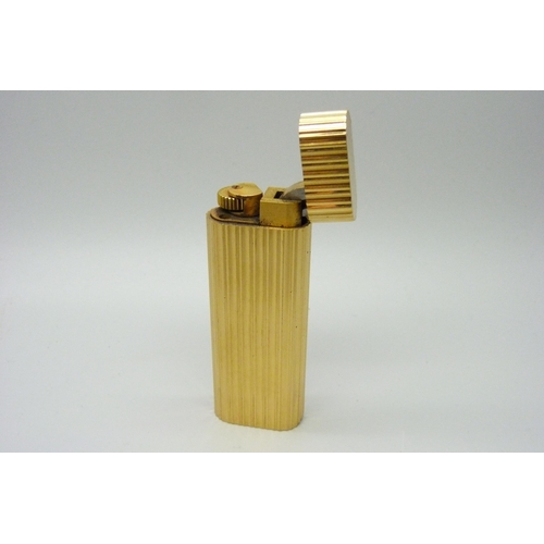 1083 - A Cartier gold plated cigarette lighter