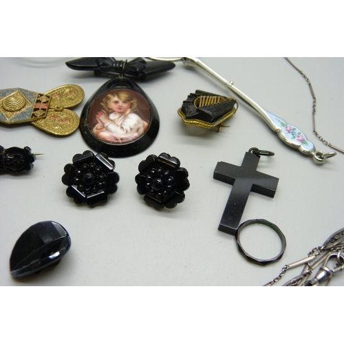 1098 - A pair of lorgnettes, a harp brooch, an enamelled watch case back, a belt buckle, etc.