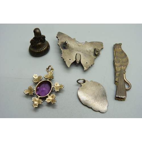 1110 - A purple paste set pendant with seed pearls, a silver butterfly brooch, a/f, a fob etc.