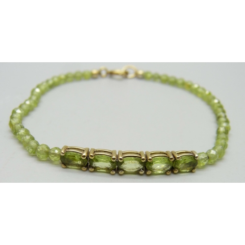 1162 - A silver gilt and peridot bracelet, 19.5cm