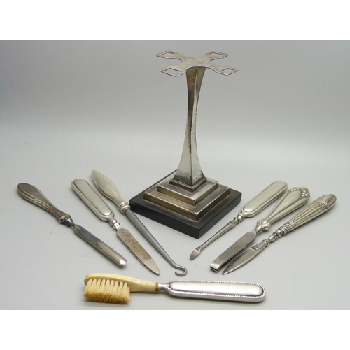 1167 - An Art Deco manicure stand, Birmingham 1935 and seven tools, six have silver handles