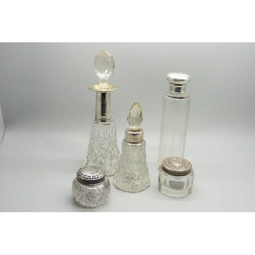 1168 - Silver topped jars, two scent bottles with silver collars, one stopper a/f, one bottle lid a/f