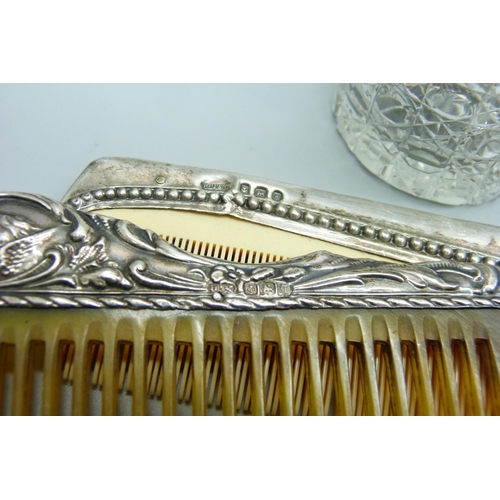 1172 - A silver topped jar decorated with Reynolds Angels, Chester 1905 and two silver mounted combs