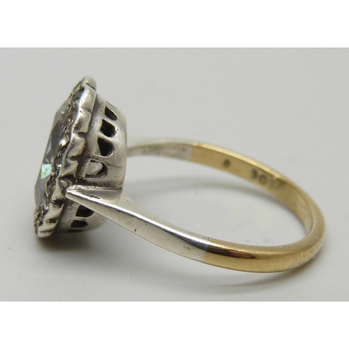 1174 - A 9ct gold ring set with a large white stone and paste halo, 3.7g, N