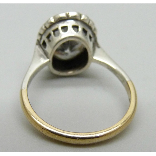 1174 - A 9ct gold ring set with a large white stone and paste halo, 3.7g, N