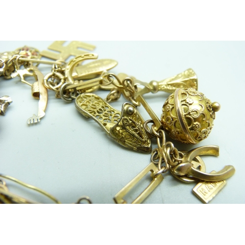 1195 - A 9ct gold charm bracelet, 31.8g gross