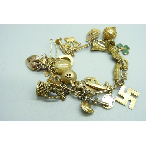 1195 - A 9ct gold charm bracelet, 31.8g gross