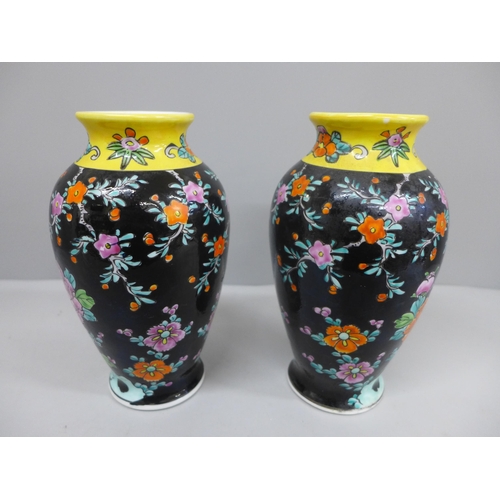 614 - A pair of hand-painted vases decorated with birds